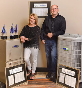 Bill and Peg Next to Carrier Unit and Carrier Cooling Awards