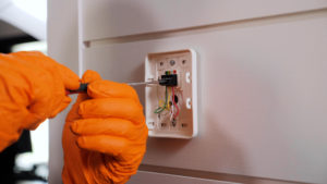 Technician working on electrical thermostat